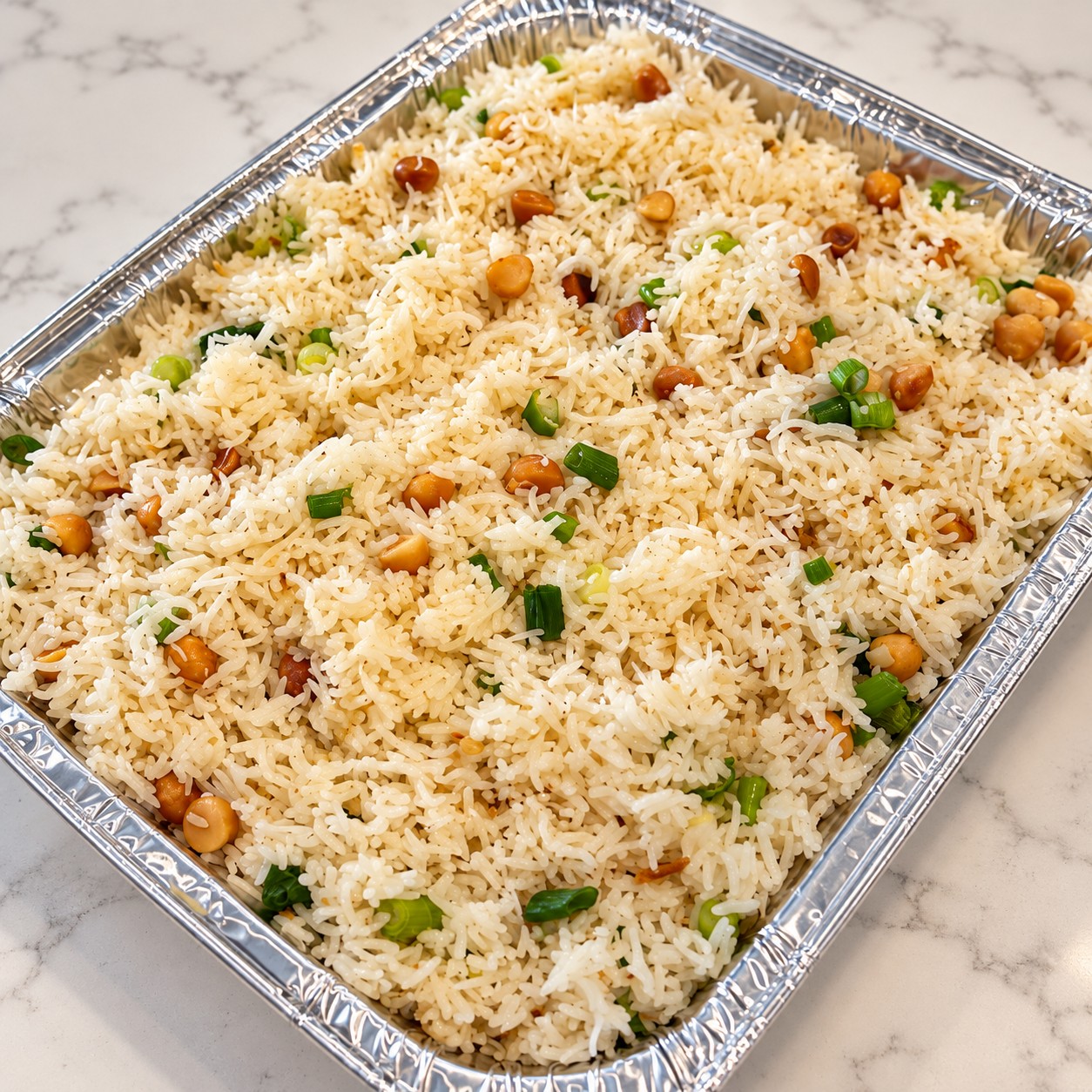 A tray of seasoned rice with chickpeas and green onion